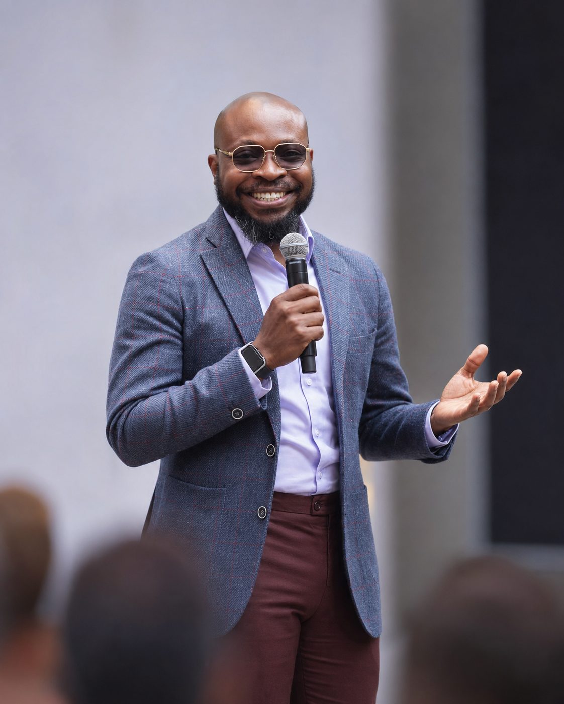Blaise Itabelo speaking on stage at a professional event