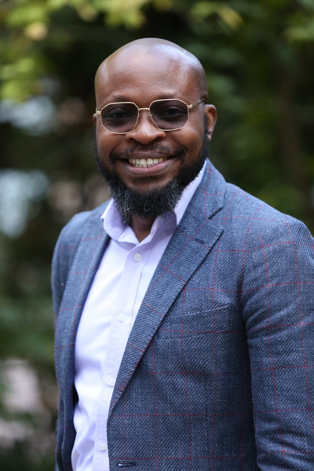 Blaise Itabelo outdoors in a navy blazer, reflecting international program leadership